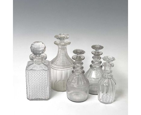 A pair of Regency triple ring neck glass decanters and stoppers, with faceted and fluted decoration, height 21cm, together wi