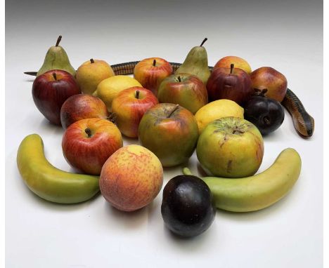 A collection of assorted wax fruit, including apples, bananas, lemons and pears, together with an articulated toy snake.Condi