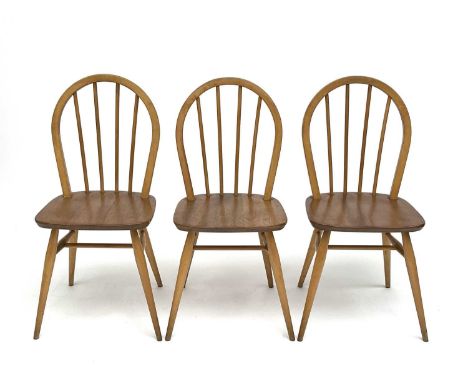 A set of three Ercol beech and light elm hoop back dining chairs, stamped to the underside with kitemark and dated 1960, heig