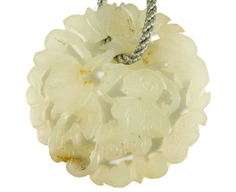 A Chinese carved jade circular pendant. Diameter 5.5cm.