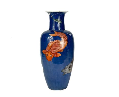 A Chinese blue ground porcelain vase, 19th century. In the Kangxi style, decorated with fish, blue double rings, height 45.5c