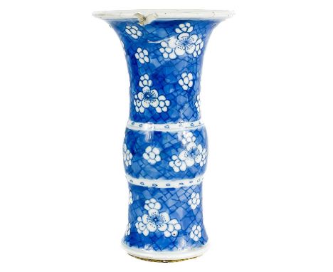 A Chinese prunus pattern blue and white porcelain Gu vase, late Kangxi. With a flared top rim, the blue cracked ice ground wi