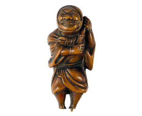 A Japanese carved wood netsuke, Meiji period, signed. The elderly figure carrying a small staff and bag, 5 x 2.5cm.