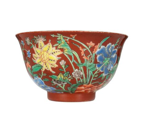 A Chinese famille rose porcelain bowl, 20th century. Blue Kangxi yuzhi mark, the coral ground painted with flowers in famille