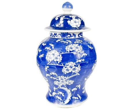 A Chinese porcelain prunus pattern vase, late 19th century. With associated cover, four character Kangxi mark, height 33.5cm,