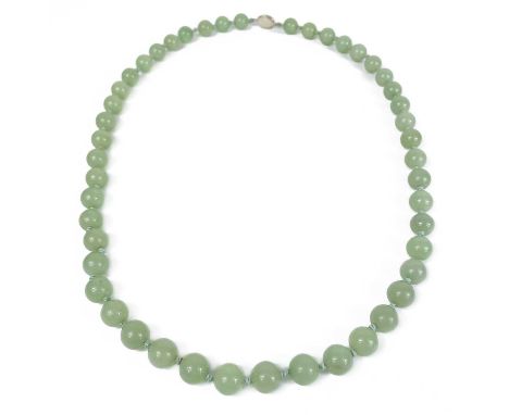 A Chinese jade bead necklace, mid 20th century. The clasp stamped 'Silver, Made in China', length 82cm, case 30 x 6cm.