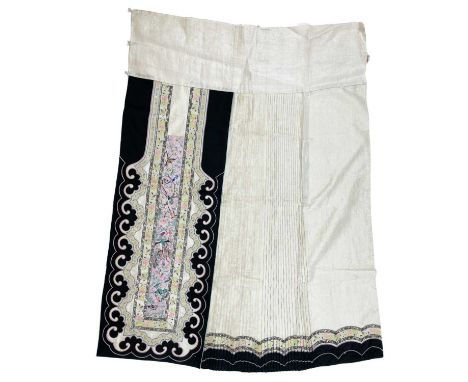 A Chinese silk embroidered skirt, 19th century. The pink rectangular panel decorated with colourful birds and flowering branc