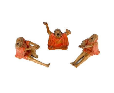 A Japanese painted wood netsuke, Meiji period. Height 5.5cm, width 4cm, depth 2.5cm and two similar figures. (3)One arm lost 