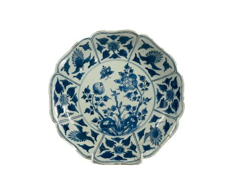 A Chinese blue and white porcelain lobed dish, Kangxi period. The central roundel enclosing a butterfly and plants, the borde