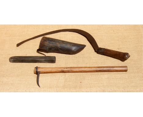 A FAGGING HOOK, RUBSTONE BOX AND STONE, AND A FAGGING STICK. All 19th century. The wooden hone box with a waist belt clip is 