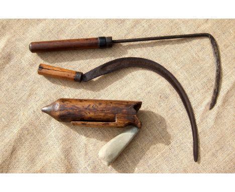 A REAPER’S SICKLE, CARVED WOODEN RUBSTONE BOX WITH STONE, AND A CORN STICK. Mid-19th century. The shaped box was belt-hung. T