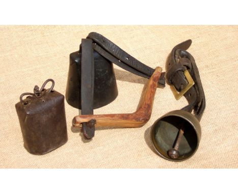 A SHEEP’S CUP BELL, CANISTER BELL AND A WIDE MOUTH BELL. The cup on a strap and the canister, 18th century. The wide mouth be