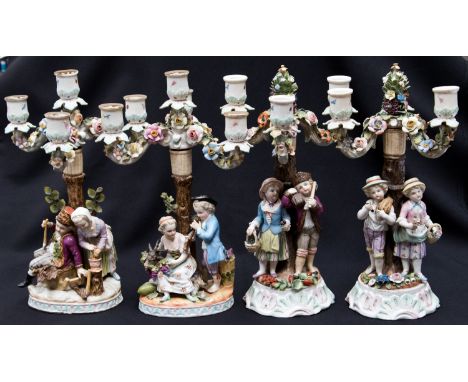 *A group of four Dresden figural candelabra, four seasons, each with a pair of figures engaged in different activities, remov