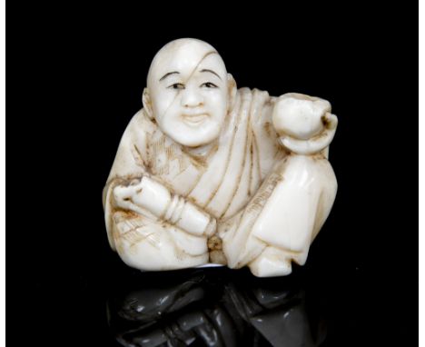 An oriental ivory netsuke, carved as a seated man with a gourd, height 3.5cm