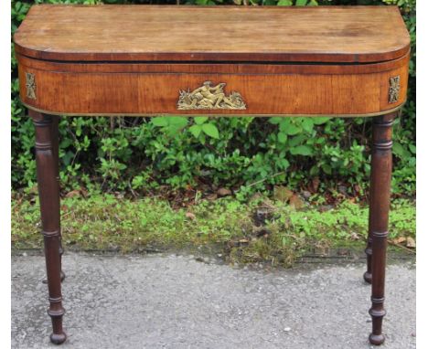 A late George III mahogany card table, circa 1815, the front with an ormolu mount depicting a Classical man seated and furthe