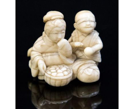 An Oriental ivory netsuke, carved as a mother an child with a basket of gourds, height 4cm