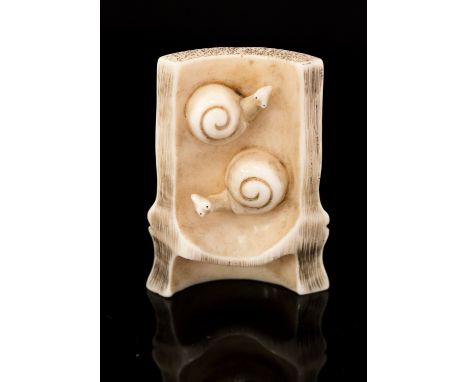 An Oriental bone/ivory netsuke, carved as a log with two snails on, signed, height 4.5cm