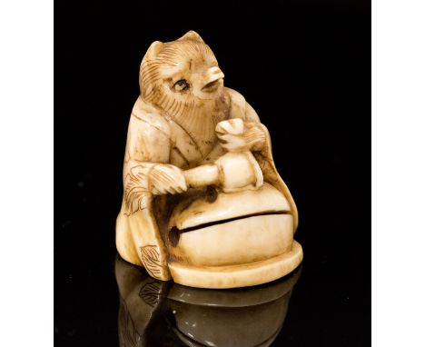 An Oriental ivory netsuke, carved as a robed fox with a gourd, signed, height 3cm