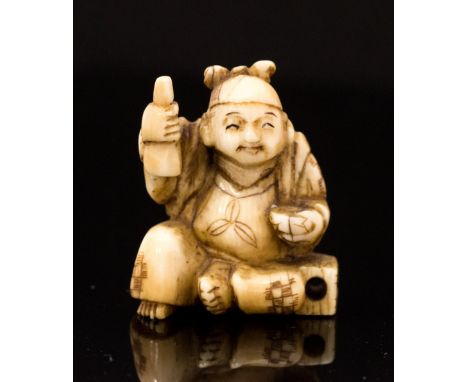 An Oriental ivory netsuke, carved as a seated man with a bowl, signed, height 3cm