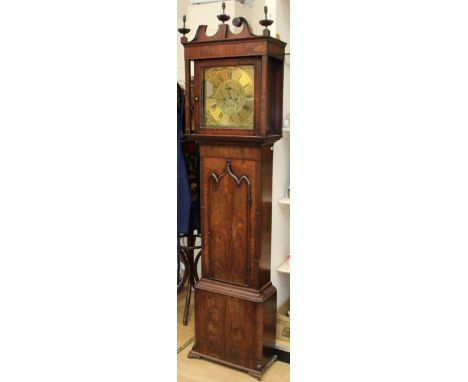 A George III mahogany eight day longcase clock, the hood with a swan neck pediment and turned finials, brass dial with Roman 