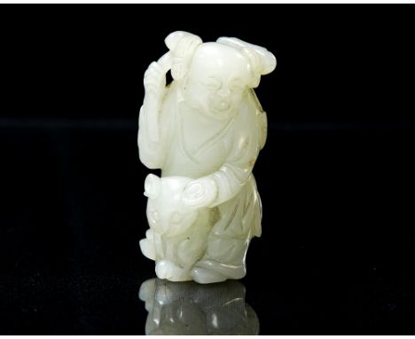 A Chinese carved jade pendant modelled as a boy sitting on a cat, holding a branch, 5.5cm long