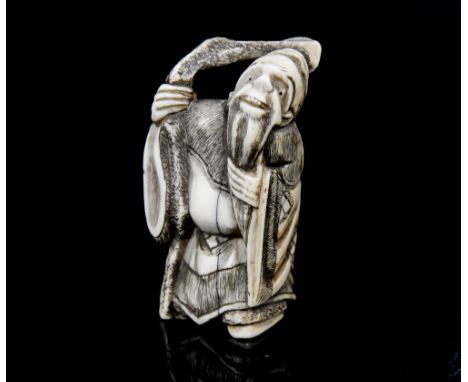 An Oriental ivory netsuke, carved as a bearded man wearing a robe, height 5cm