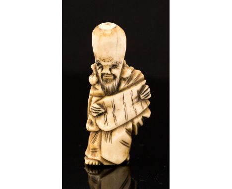 An oriental carved bone netsuke, in the form of Hotei standing with a parchment, height 6cm