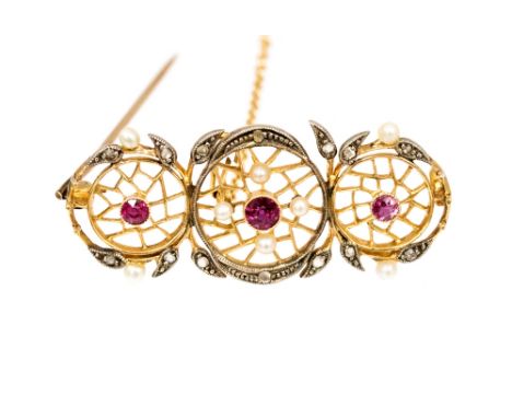 An Edwardian ruby, diamond and seed pearl yellow metal brooch, each circular motif set with a ruby and pierced fretwork desig