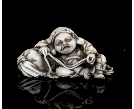 An oriental ivory netsuke, carved as resting weary traveller, width 4cm