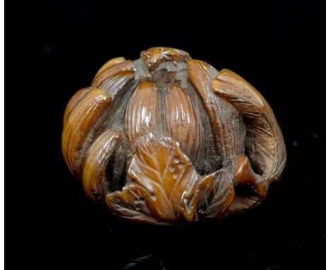 An Oriental stained netsuke in the form of a gourd, width 2.5cm