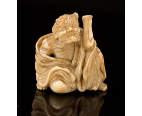 An Oriental ivory netsuke, carved as a seated immortal, height 3cm (s.d)