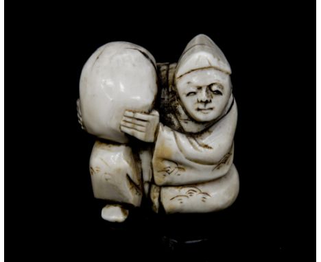 An Oriental bone/ivory netsuke, carved as a seated man showing off a large gourd, height 3cm