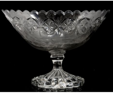 An early 19th century glass pedestal bowl, circa 1820, the oval, flared bowl with  crenellated rim and mitre cut star banding