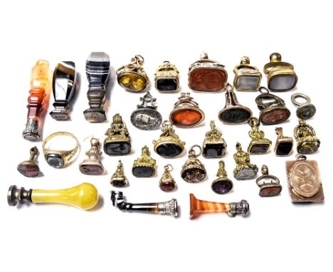 An assorted collection of 19th Century and later wax seals, to include gilt metal fob mounted seals, polished agate handled s