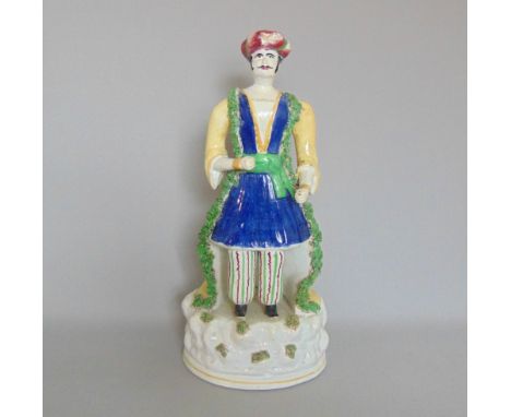 A large Staffordshire figure of a Turk, probably Dudson, circa 1840, height 37cm

Condition: Restoration to neck, left arm at