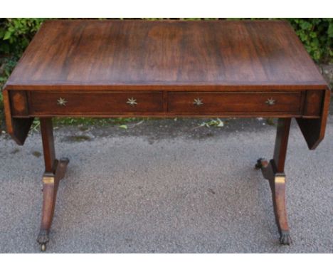 A George IV rosewood sofa table, circa 1825, the top with a cross-banded edge, the front fitted with two drawers, each end wi