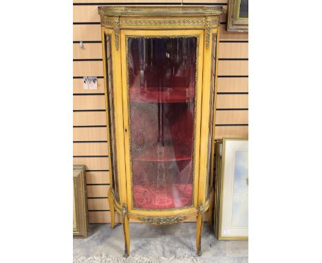 An early 20th Century satinwood bow-fronted display cabinet, the marble top with a brass gallery to edge, the front with a si