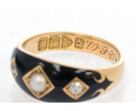 An Edwardian mourning ring, black enamel, pearl set to centre with a small old cut diamond either side, total diamond weight 