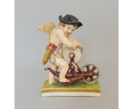 *An English porcelain figure of cupid grinding an arrow, emblematic of fire, possibly Rockingham, circa 1830, height 11cm

Co