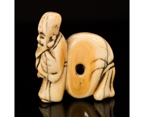 An Oriental ivory netsuke, carved as Hotei with a large backpack, width 3.5cm