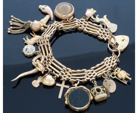 A 9ct gold gate bracelet, with padlock clasp and eighteen charms including fobs set with bloodstone and cornelian, approximat