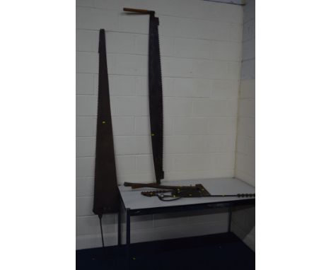 A VINTAGE DOUBLE HANDLED LUMBERJACK CROSS CUT SAW, length 196cm, together with another large vintage saw, length 248cm, two d
