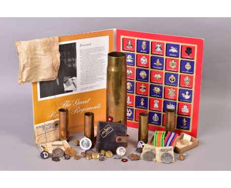 A BOX OF MILITARIA to include 'Texaco' folder of reproduction cap badges, 'The Great British Regiments', a 1917 4'' shell cas