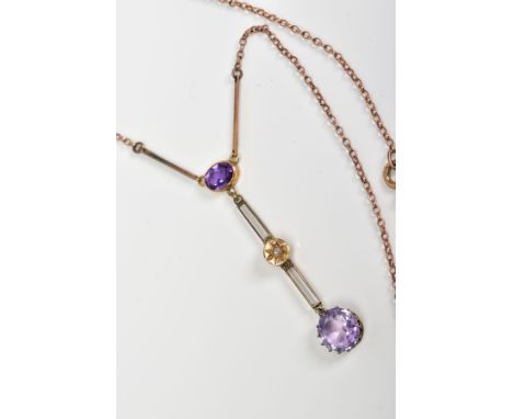 AN EDWARDIAN AMETHYST AND DIAMOND DROP PENDANT NECKLACE, designed with an oval cut amethyst suspending an open work bar with 