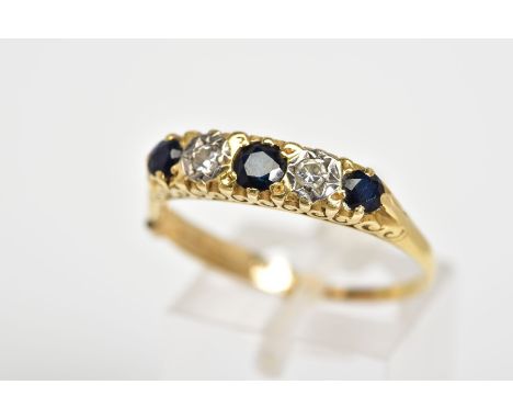 A FIVE STONE RING, designed as a row of circular cut sapphires interspaced by round brilliant cut diamonds, with scrolling ga