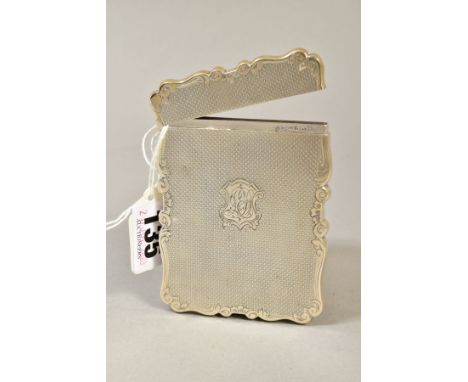 A LATE VICTORIAN SILVER CARD CASE OF WAVY RECTANGULAR OUTLINE, hinged top, engine turned decoration with monogram to shield c