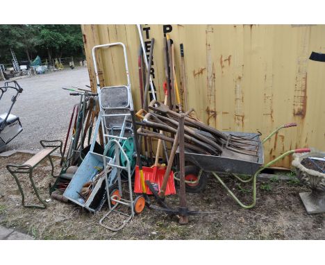 A VINTGE WEBB 10'' PUSH ALONG LAWN MOWER, a wheel barrow and a large quantity of vintage garden tools including rakes, hoes, 