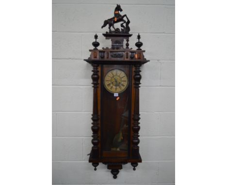 A LATE 19TH CENTURY MAHOGANY AND WALNUT VIENNA REGULATOR WALL CLOCK, with a ceramic horse pediment, the 6 1/2'' circular dial