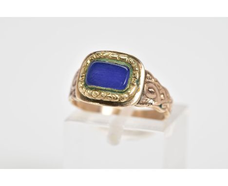 A VICTORIAN MOURNING RING, designed with a square central panel set with a blue panel and engraved surround and shoulders, ri
