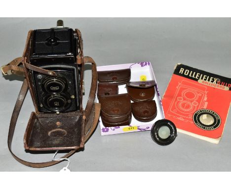 A ROLLEIFLEX OLD STANDARD TLR CAMERA with Tessar 3.5 75mm lenses, tatty leather case, and four leather cases with lenses, fil